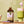 Bottle of Lavender Syrup with an iced matcha latte and lavender foam being poured.