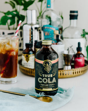 True cola shot with bar items and cocktail